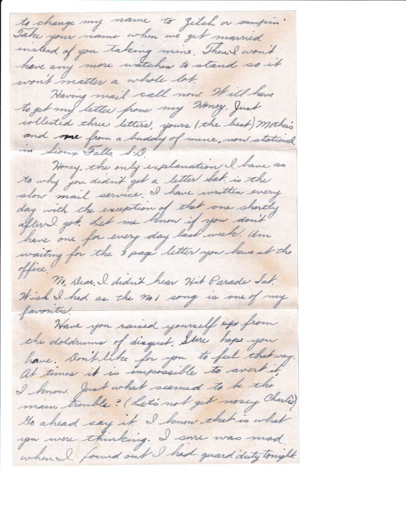 A handwritten letter with cursive text on stained paper.