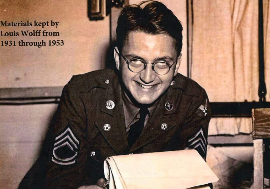 A smiling soldier in uniform reads a letter indoors.